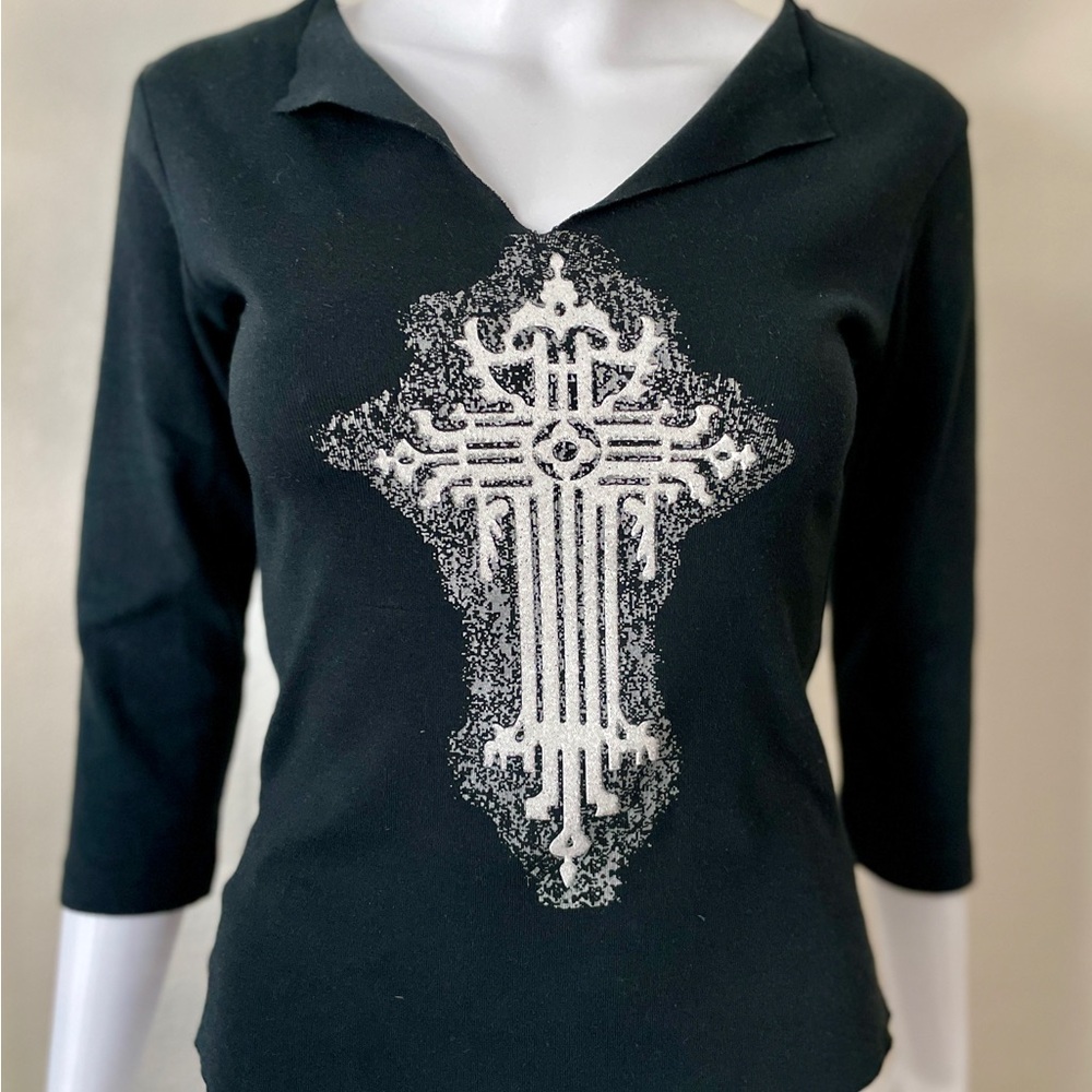 Black three-quarter sleeve top, white and silver beaded textured cross on front.